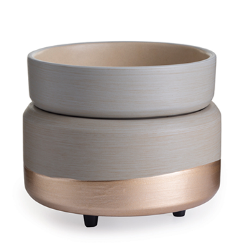 The Midas wax melt warmer has a matte beige top with a coppery gold shine that wraps around the bottom