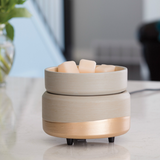 The Midas wax melt warmer is shown with wax melts in its top dish