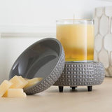 The slate 2-in-1 wax melt warmer sits disassembled with a 10 oz. candle sitting on the warming plate and wax melts sitting in the top dish